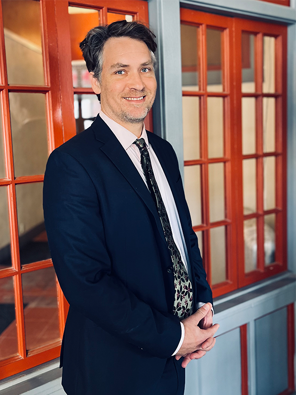 Shane-zisman-image Lawyer Attorney Bankruptcy expert Shane Zisman stands outside of his office in Fairfield Iowa smiling