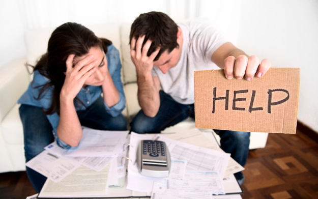 bankruptcy-image A couple are looking at their bills holding up a sign that says "Help" letting you know that Laywer attorney Shane Zisman can help you file for Bankruptcy in Ottumwa Mt. Pleasant and Burlington Iowa