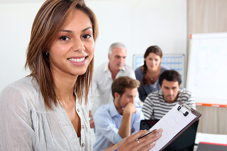 Business woman with brown hair holds a clip board while discussing business formation letting you know that LAWYER attorney Shane Zisman can help you file All forms of paperwork to form your business